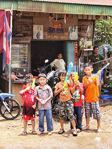 Boys armed with water guns stand in front of the house in Battambang, Cambodia, getting ready for Songkran festival - water festival, on Khmer New Year, photo by Ivan Kralj