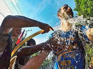 Pipeaway blogger Ivan Kralj getting splashed with water during the bike ride in Battambang, Cambodia, on the occasion of Khmer New Year - Songkran water festival, photo by Ivan Kralj