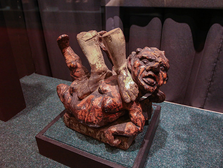 Trampled Devil, a part of the artwork from the 18th century, in which Archangel Michael is trampling the rebellious devil. The priest Juozas Tumas-Vaižgantas gave it as a present to Antanas Žmuidzinavičius, but sawed the archangel off, as the sculpture was too high to get transported by train. Today it is displayed in Devil's Museum in Kaunas, Lithuania, photo by Ivan Kralj