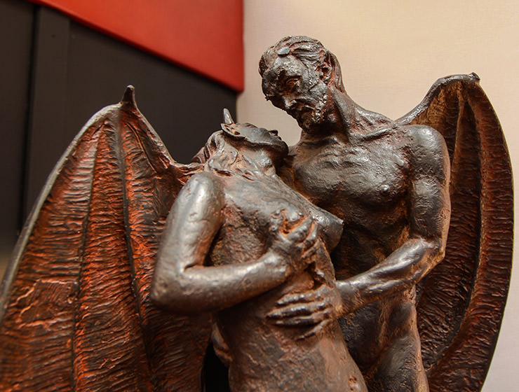 Sculpture of a winged devil holding a naked woman in his arms, displayed at Devil's Museum in Kaunas, Lithuania, photo by Ivan Kralj