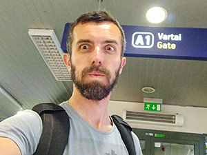 Blogger Ivan Kralj making the face of relief after making it to the gate at Vilnius Airport only 20 minutes after waking up - tiredness connected to travel fogginess experiences takes its toll, photo by Ivan Kralj