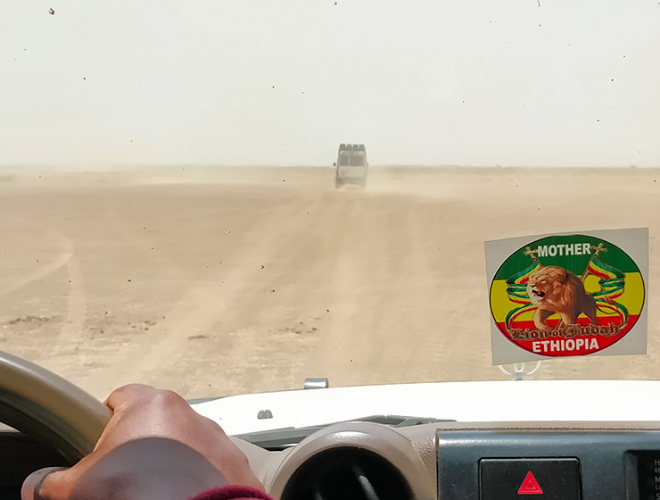 Driving through the dusty desert in Toyota Land Rovers, in Danakil Depression, Ethiopia, the hottest place on Earth, photo by Ivan Kralj