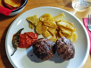 Mimi Ivanova meetballs with Bulgarian French fries, lyutenitsa and chili pepper at Pavaj Restaurant in Plovdiv, Bulgaria, the oldest city in Europe, photo by Ivan Kralj