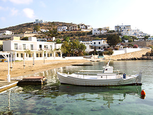 Fisherman's boat anchored at Achladi Beach on Syros Island, in front of the Hotel Emily, one of the best beachfront hotels in Cyclades Islands