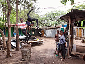 Girls training partnered contortion on the barrel in the courtyard of Arba Minch Circus, Ethiopia, photo by Ivan Kralj