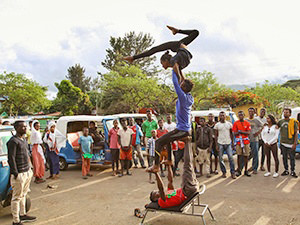 A group of acrobats from Arba Minch Circus pulls of for an impromptu street performance in Arba Minch, Ethiopia, while the crowd gathers around them, photo by Ivan Kralj