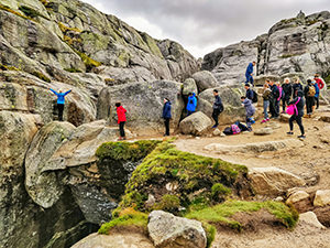 Back side view of the Kjeragbolten - people queuing up to take photos on the famous Kjerag boulder in Norway, photo by Ivan Kralj