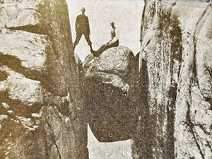 Old photograph of people posing on Kjeragbolten, a famous boulder on Kjerag Mountain, Norway, photo by Ivan Kralj