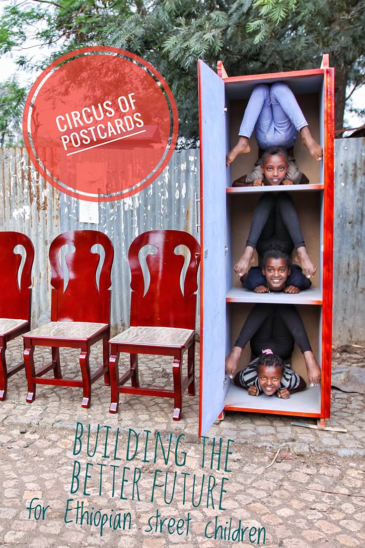 Arba Minch Circus contortionist girls backbending while squeezed into the closet displayed in the street of Arba Minch, Ethiopia. "Circus of Postcards" is a fundraising project to build better training facilities for this social circus. Help it out by buying postcards with images displaying their acrobatic talent!