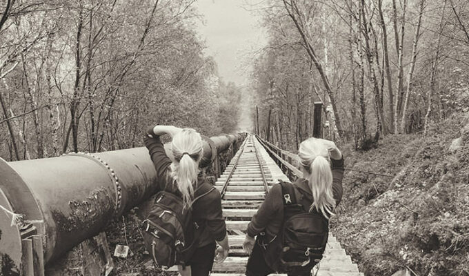 Two female hikers standing on the top of Flørli stairs - with 4444 stairs, it is the longest staircase in the world, at Lysefjord, Norway
