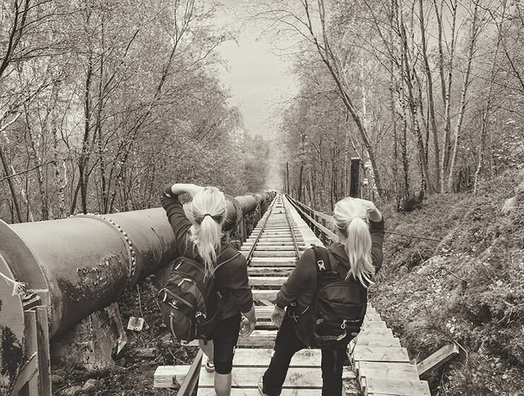 Two female hikers standing on the top of Flørli stairs - with 4444 stairs, it is the longest staircase in the world, at Lysefjord, Norway