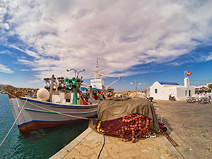 Fishermen boat and nets in front of the Church Agios Nikolaos in Naoussa, Paros, Greece, photo by Ivan Kralj