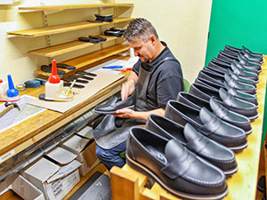 Worker in the workshop of Aurland Shoe Factory making Aurland shoes, in Norway, photo by Ivan Kralj