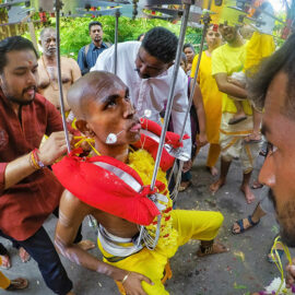 Prakash J Govindarajoo family piercing him as a preparation for Thaipusam Festival 2019, his tongue and cheeks are pierced with spike, photo by Ivan Kralj