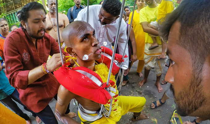 Prakash J Govindarajoo family piercing him as a preparation for Thaipusam Festival 2019, his tongue and cheeks are pierced with spike, photo by Ivan Kralj