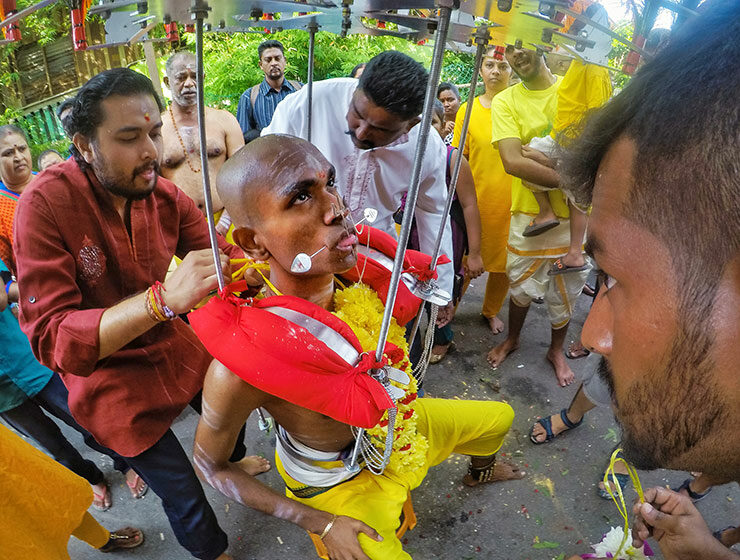 Prakash J Govindarajoo family piercing him as a preparation for Thaipusam Festival 2019, his tongue and cheeks are pierced with spike, photo by Ivan Kralj