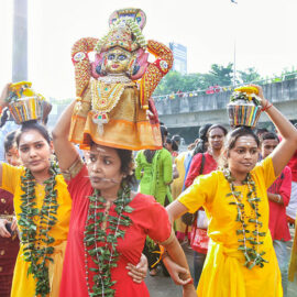 Three female devotees with pierced tongues, carrying paal kudam at Thaipusam Festival 2019 at Batu Caves, Malaysia, photo by Ivan Kralj