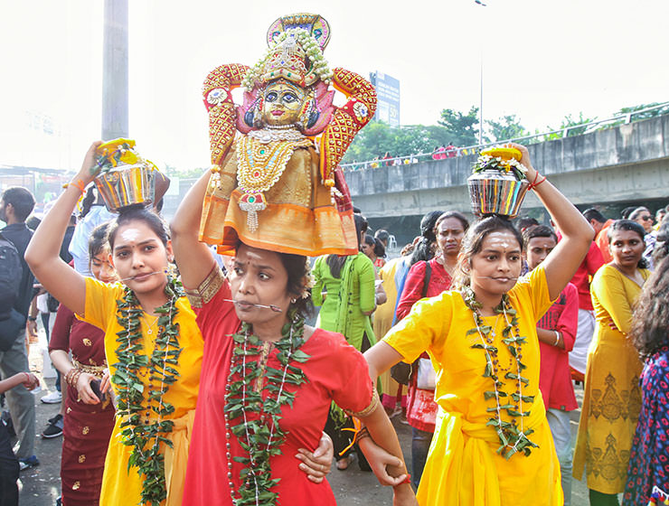 Three female devotees with pierced tongues, carrying paal kudam at Thaipusam Festival 2019 at Batu Caves, Malaysia, photo by Ivan Kralj