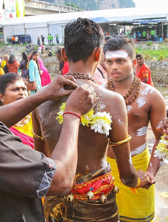 Young man having his back skin pierced with flowers at Thaipusam Festival 2019 at Batu Caves, Malaysia, photo by Ivan Kralj
