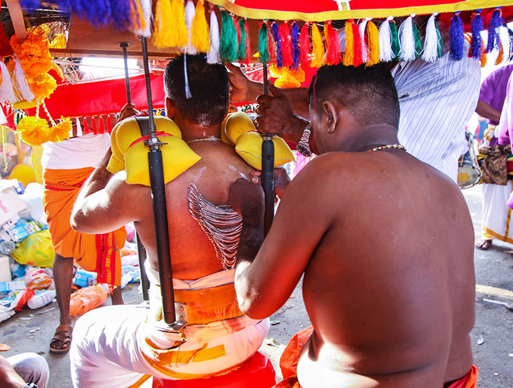 Devotee having his back skin pierced with jewelry chains at Thaipusam Festival 2019 at Batu Caves, Malaysia, photo by Ivan Kralj