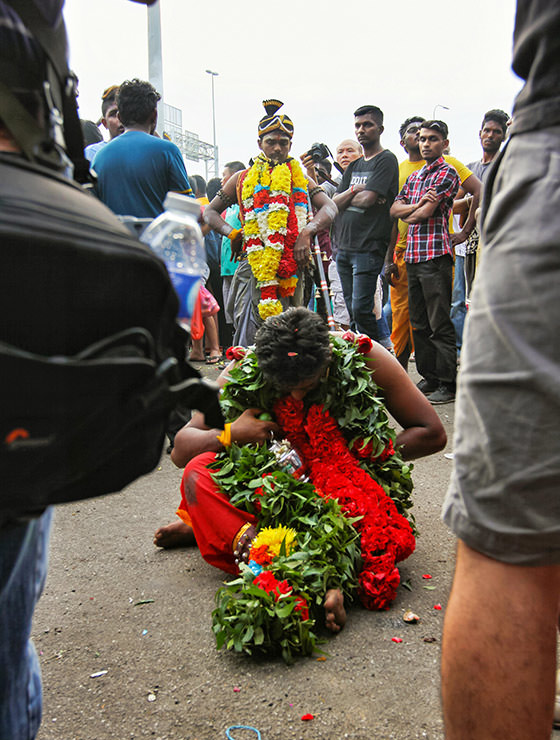 Devotee sitting on the floor at Thaipusam Festival 2019 at Batu Caves, Malaysia, photo by Ivan Kralj