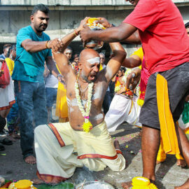 Devotee screaming while putting paal kudam milk pot on his head, at Thaipusam Festival 2019 at Batu Caves, Malaysia, photo by Ivan Kralj
