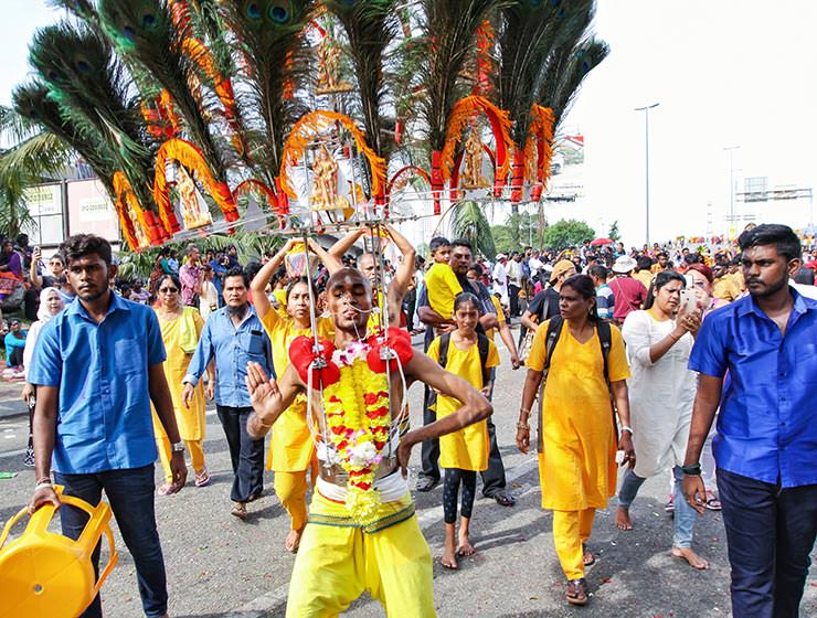 Devotee Prakash J Govindarajoo carrying a peacock-feathers-decorated kavadi at Thaipusam Festival 2019 at Batu Caves, Malaysia, photo by Ivan Kralj