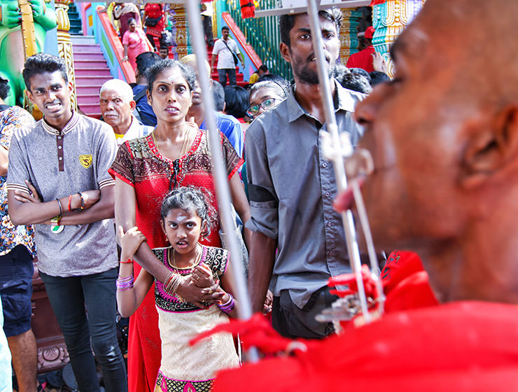 Shocked onlookers watching the pierced devotee passing by at Thaipusam Festival 2019 at Batu Caves, Malaysia, photo by Ivan Kralj