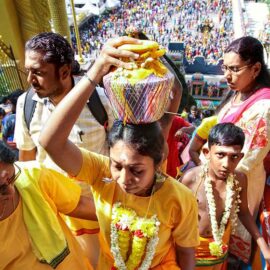 Devotee carrying paal kudam climbing the 272 stairs to Batu Caves, Malaysia, during the Thaipusam Festival 2019, photo by Ivan Kralj