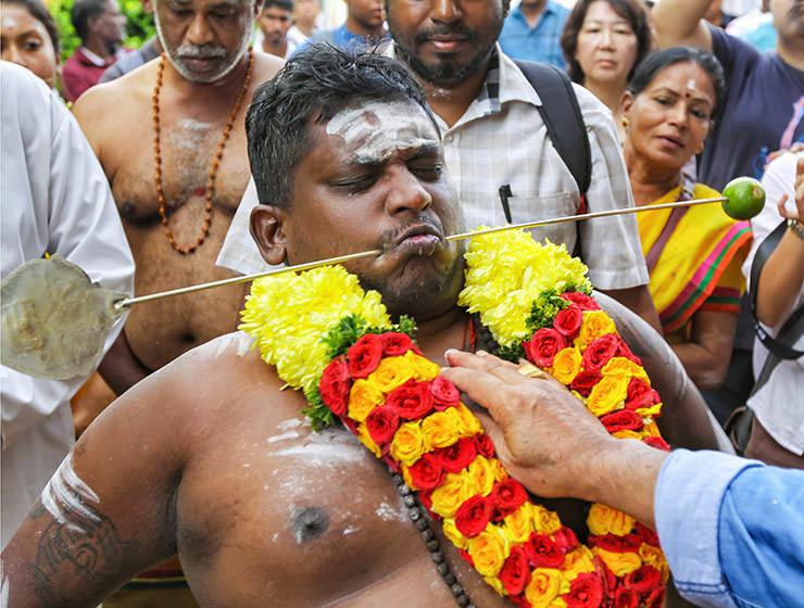 Devotee with pierced cheeks at Thaipusam Festival 2019 at Batu Caves, Malaysia, photo by Ivan Kralj