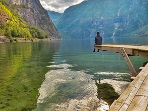 Pipeaway blogger sitting on the pier on Vassbygdevatnet Lake in Aurland, Norway, photo by Ivan Kralj