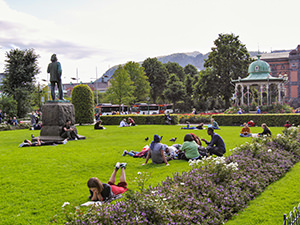 People resting on the grass at Byparken in Bergen, Norway, the wettest place in Europe, photo by Ivan Kralj