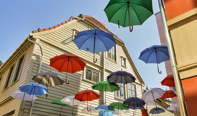 Decorative umbrellas floating in the air above one bar in Bergen, the rainiest city in Europe, photo by Ivan Kralj