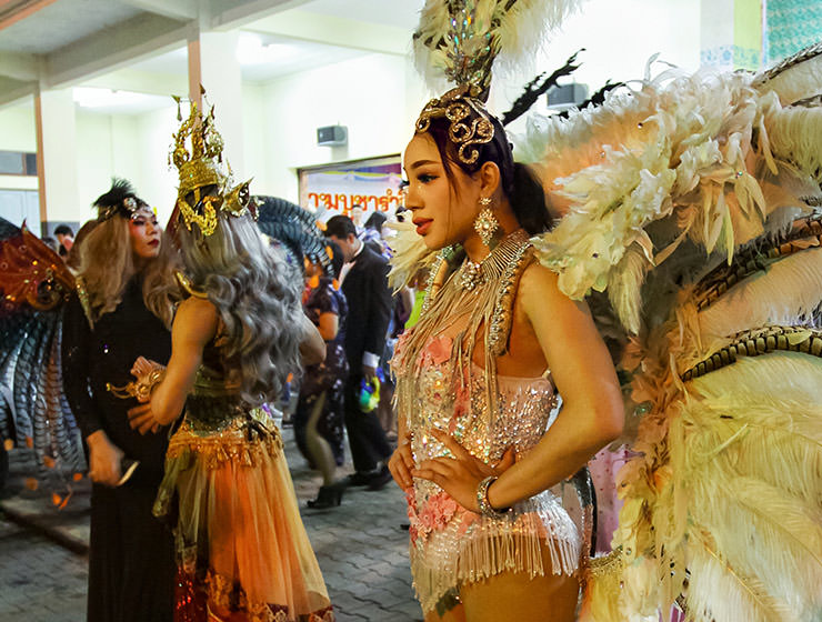 Participant dressed in feathers posing at Chiang Mai Pride, gay parade in Chiang Mai, Thailand, photo by Ivan Kralj