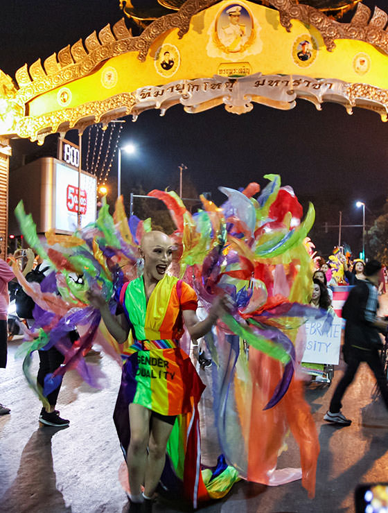 Bald ladyboy walking in rainbow-colored costume at Chiang Mai Pride, gay parade in Chiang Mai, Thailand, photo by Ivan Kralj