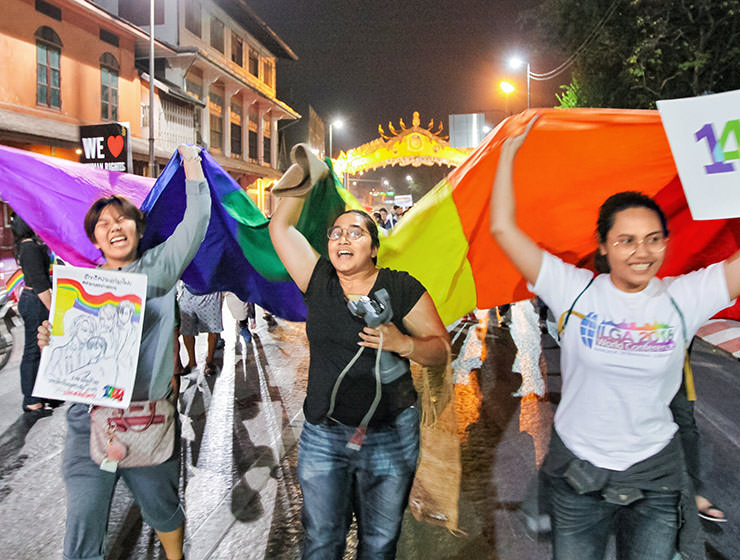 Participants shouting while walking with a huge rainbow flag at Chiang Mai Pride, gay parade in Chiang Mai, Thailand, photo by Ivan Kralj