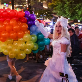 Participant in the white wedding dress in front of the rainbow-colored balloons at Chiang Mai Pride, gay parade in Chiang Mai, Thailand, photo by Ivan Kralj
