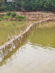 Shaky looking bamboo bridge over the Nam Khan River; visiting the bridge is considered to be one of the best things to do in Luang Prabang, Laos, photo by Ivan Kralj