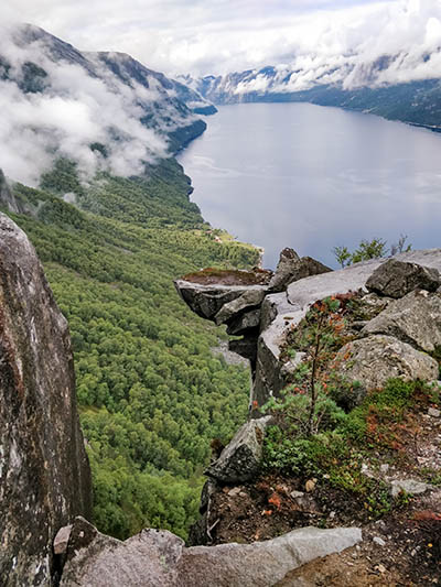 Kalleliklumpen boulder rock hovering over the abyss at Lysefjord in Norway, photo by Ivan Kralj.