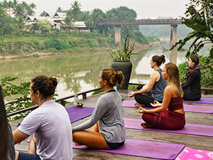 Yoga practitioners at Utopia on the banks of Nam Khan River, one of the best things to do in Luang Prabang, Laos, photo by Ivan Kralj