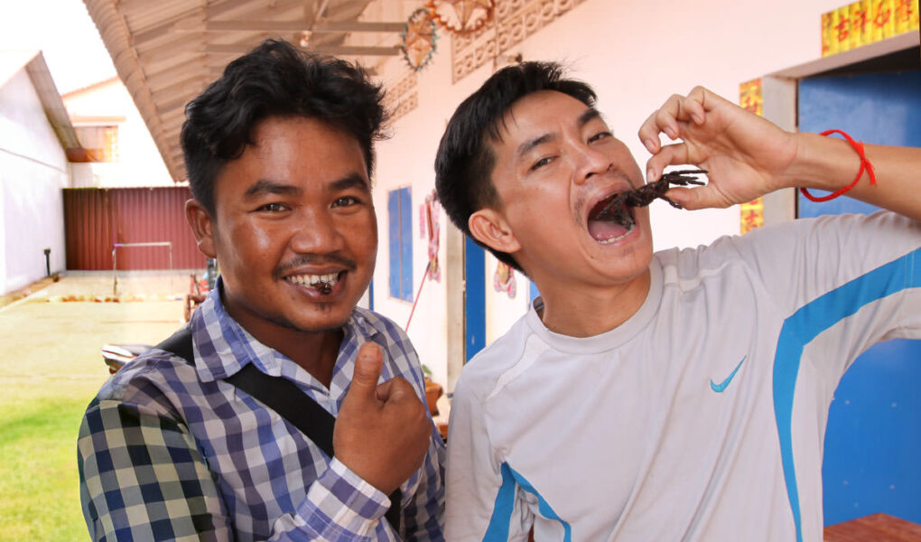 Cambodians eating a cricket and a scorpion at Fear Factor Challenge, a Backstreet Academy cooking class in Siem Reap, Cambodia, the country where people love eating insect food, photo by Ivan Kralj.