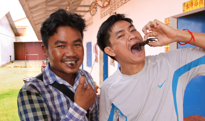 Cambodians eating a cricket and a scorpion at Fear Factor Challenge, a Backstreet Academy cooking class in Siem Reap, Cambodia, the country where people love eating insect food, photo by Ivan Kralj.