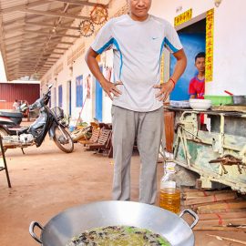 Experience host Ratana Ouch monitoring the frying of the crickets at Backstreet Academy's Fear Factor Challenge cooking class in Siem Reap, Cambodia, a country where they love eating insects, photo by Ivan Kralj