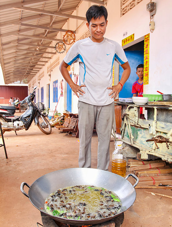 Experience host Ratana Ouch monitoring the frying of the crickets at Backstreet Academy's Fear Factor Challenge cooking class in Siem Reap, Cambodia, a country where they love eating insects, photo by Ivan Kralj