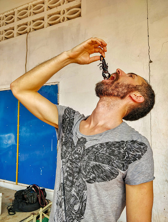 Pipeaway blogger Ivan Kralj holding a scorpion above his mouth at Backstreet Academy's Fear Factor Challenge in Siem Reap, Cambodia, the country where they love eating insects, photo by Kim Peou