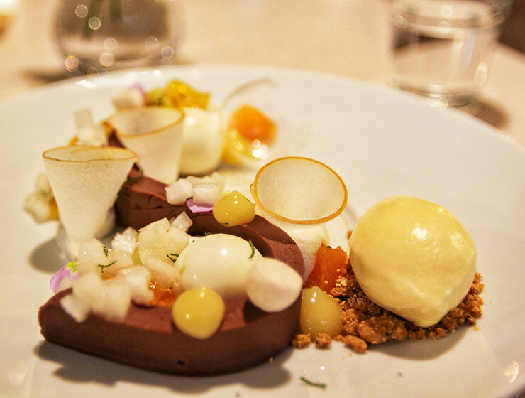 Chocolate Fair (Pear) dessert made of milk chocolate ganache, pear-lemon mousse, Chartreuse cream, pear gel, fresh mint slice, fresh pear dice and slice, honey-lemon coulis, fruit chips and sugar tuile, artistically served on a plate in Sona dessert cafe in Seoul, South Korea, one of the places to try the best Korean desserts in Seoul, photo by Ivan Kralj