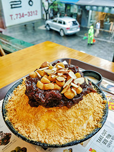 Injeolmi Bingsu, an ice-flakes bowl topped with Injeolmi, a rice cake with soybean powder, azuki beans and sliced almonds, one of the best Korean desserts to try in Seoul, as served in Sulbing Insadong, Seoul, South Korea, photo by Ivana Kralj