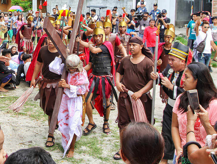 Wilfredo Salvador (62) carrying a wooden cross before going through the crucifixion in Pampanga, San Fernando, the baray of San Juan, which is one of the highlights of the Maleldo 2019, Holy Week Philippines, photo by Ivan Kralj