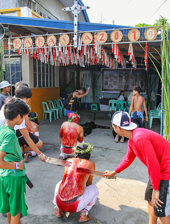 Magdarame devotees relive Christ's passion by carrying heavy crosses and flagellating themselves in San Fernando, Pampanga, during the Maleldo 2019, Holy Week Philippines, photo by Ivan Kralj