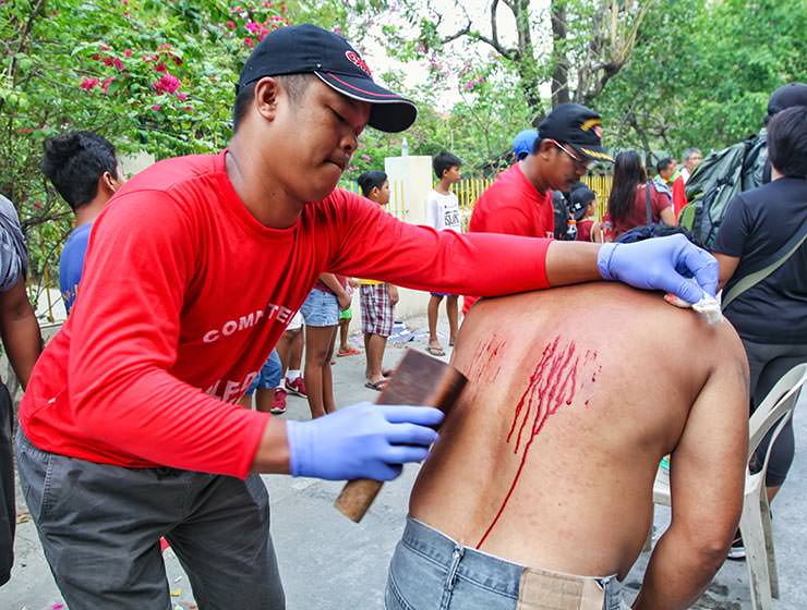 Magdarame devotees relive Christ's passion by carrying heavy crosses and flagellating themselves in San Fernando, Pampanga, during the Maleldo 2019, Holy Week Philippines, photo by Ivan Kralj